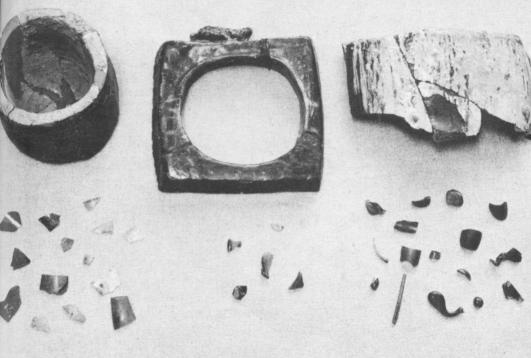 [Illustration: Artifacts found near the site of the Jamestown glasshouse which was in operation as early as 1608: a small melting pot, part of a working hole, fragment from large melting pot, cullet (broken or refuse glass shown in lower left corner), and green glass fragments (lower center and lower right).]