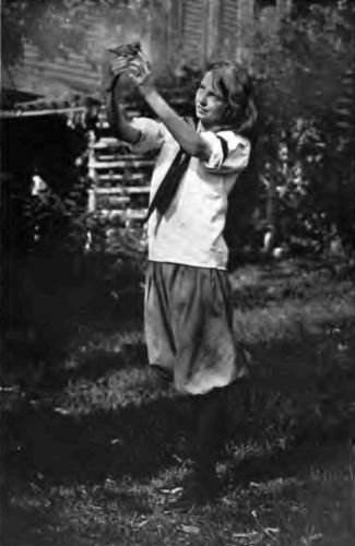 The Country Girl and Her Pets. "The quietness of the
country permits a greater spiritual and mental growth, with its
abundance of life, plant and animal, which challenges the mind to
discover its secrets."