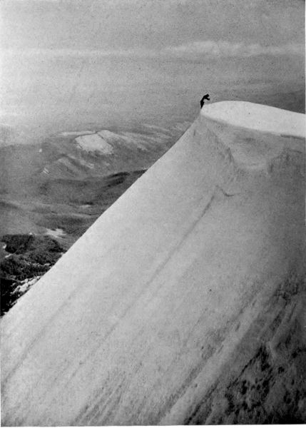 tiny man on top of huge moutain