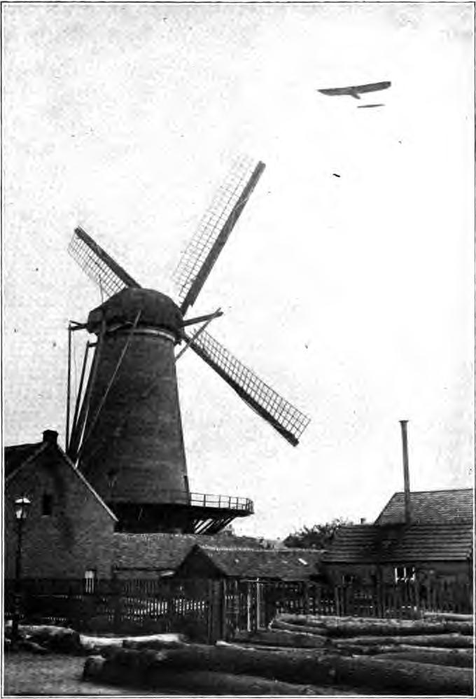 AN OLD DUTCH WINDMILL AND A MODERN FRENCH AEROPLANE